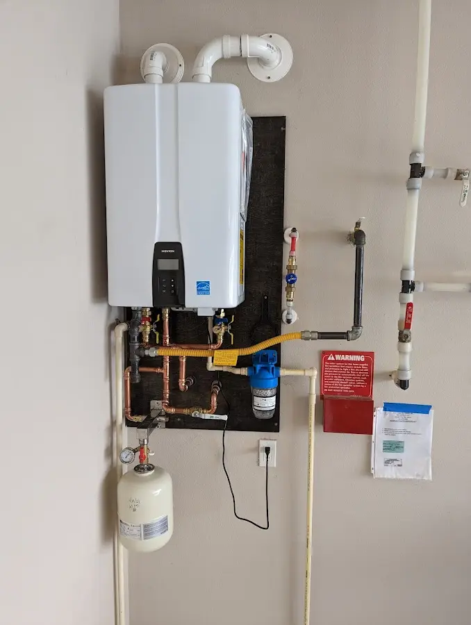 Professional plumber installing copper piping in a Keansburg home